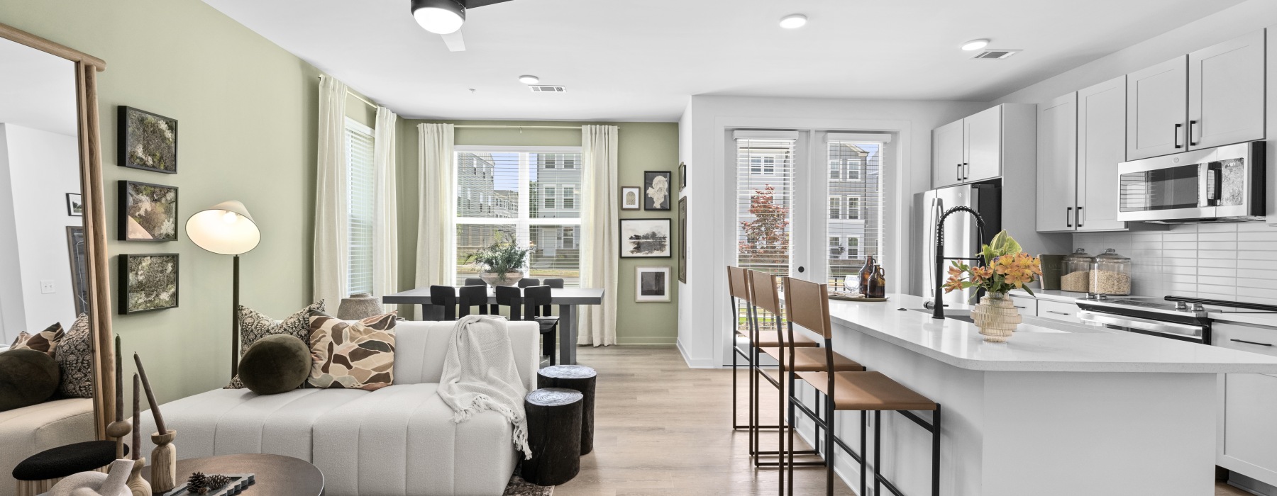 Open concept apartment with kitchen island open to living room